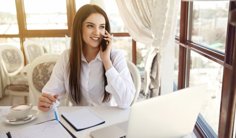 brunette-long-haired-woman-manager-is-talking-cell-phone-ar-reception